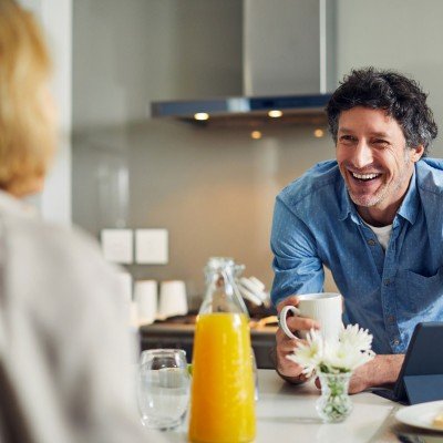 Smiling man enjoys a conversation with his wife after applying for an Expat Buy to Let mortgage with the Marsden.