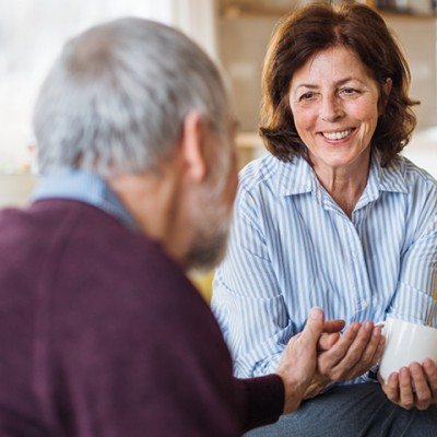Mature woman sits in her home after applying for an Older Borrower mortgage with the Marsden via her mortgage advisor.