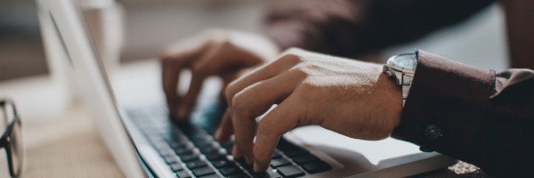 Man sits at a laptop using Affordability Calculators provided by Marsden
