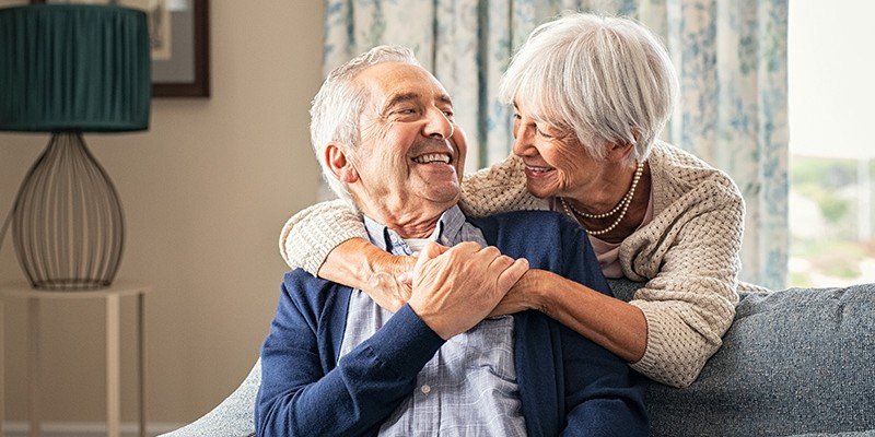 Older couple hugging at home on a sofa | Later Life mortgage case study