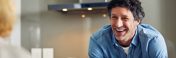 Smiling man enjoys a conversation after applying for an Expat Buy to Let mortgage on behalf of his client with the Marsden Intermediaries.