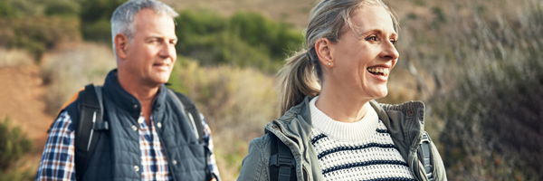 A Mature couple walking in the countryside after applying for a Lending into Retirement mortgage with Marsden Intermediaries